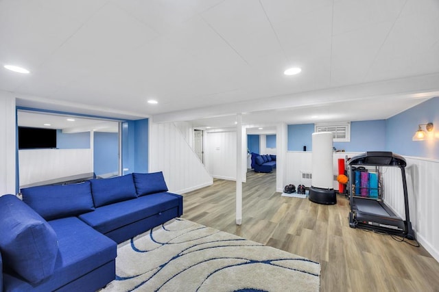 86 Woodbine Dr N, Hicksville, NY 11801 - living area featuring wood finished floors, a decorative wall, a wainscoted wall, stairs, and recessed lighting