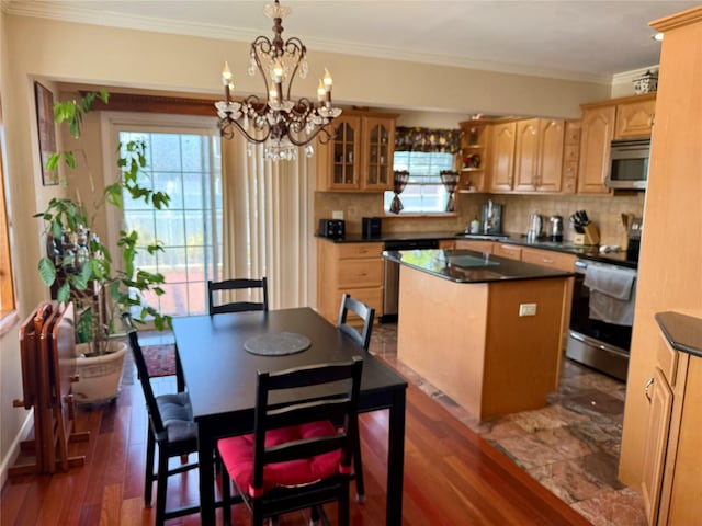 7 Ronald Ave, Hicksville, NY 11801 - kitchen with stainless steel appliances, a center island, dark countertops, tasteful backsplash, and ornamental molding