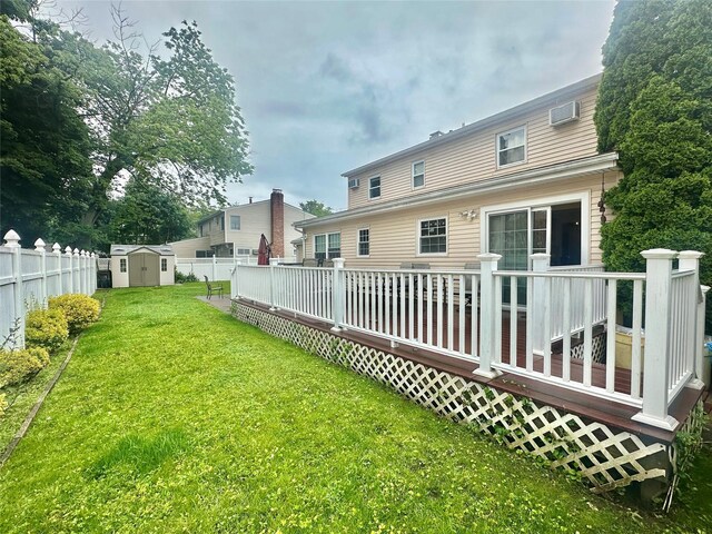 7 Ronald Ave, Hicksville, NY 11801 - back of property with a storage unit, a fenced backyard, and a wooden deck