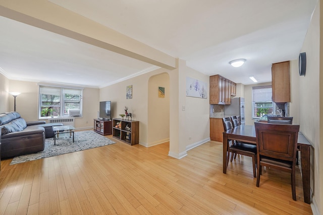 103-26 68th Ave Unit 2E, Forest Hills, NY 11375 - living area with arched walkways, healthy amount of natural light, light wood-type flooring, baseboards, and crown molding
