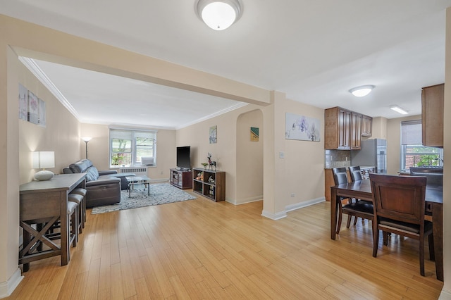 103-26 68th Ave Unit 2E, Forest Hills, NY 11375 - living area with arched walkways, ornamental molding, baseboards, and light wood-style flooring