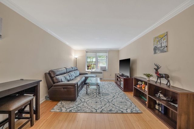 103-26 68th Ave Unit 2E, Forest Hills, NY 11375 - living room with radiator, ornamental molding, baseboards, and wood finished floors