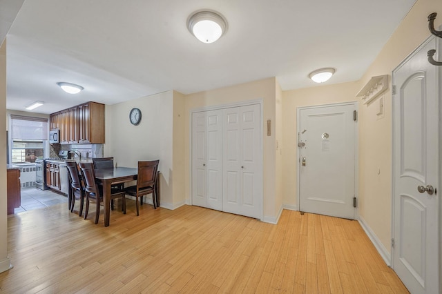 103-26 68th Ave Unit 2E, Forest Hills, NY 11375 - dining space with light wood-style flooring and baseboards