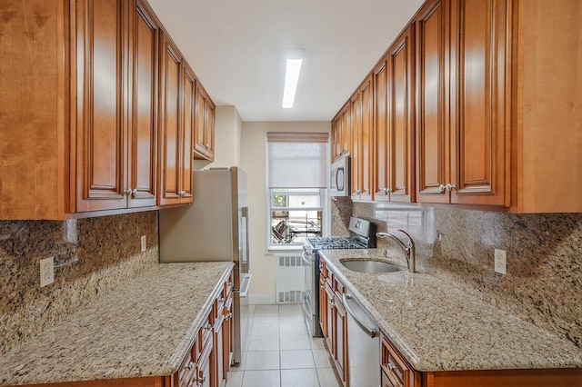 103-26 68th Ave Unit 2E, Forest Hills, NY 11375 - kitchen with stainless steel appliances, a sink, radiator heating unit, brown cabinetry, and light tile patterned floors