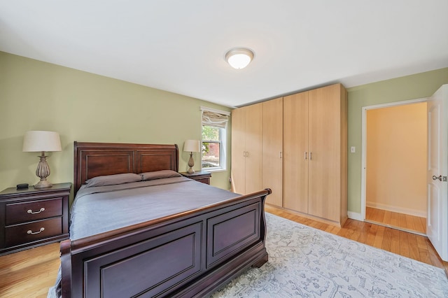 103-26 68th Ave Unit 2E, Forest Hills, NY 11375 - bedroom with light wood-style flooring, baseboards, and a closet