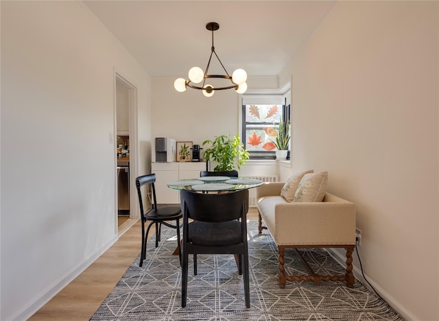 50 Brompton Unit 3K, Great Neck, NY 11021 - dining area with a chandelier, wood finished floors, radiator, and baseboards