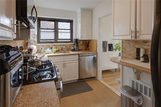 50 Brompton Unit 3K, Great Neck, NY 11021 - kitchen featuring appliances with stainless steel finishes, a sink, and backsplash