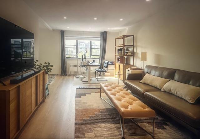 50 Brompton Unit 3K, Great Neck, NY 11021 - living area featuring light wood-type flooring, radiator heating unit, and recessed lighting