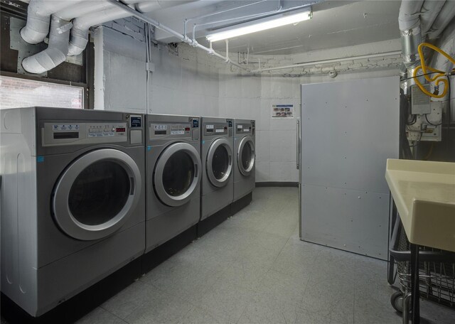 50 Brompton Unit 3K, Great Neck, NY 11021 - communal laundry room featuring washer and clothes dryer and tile patterned floors