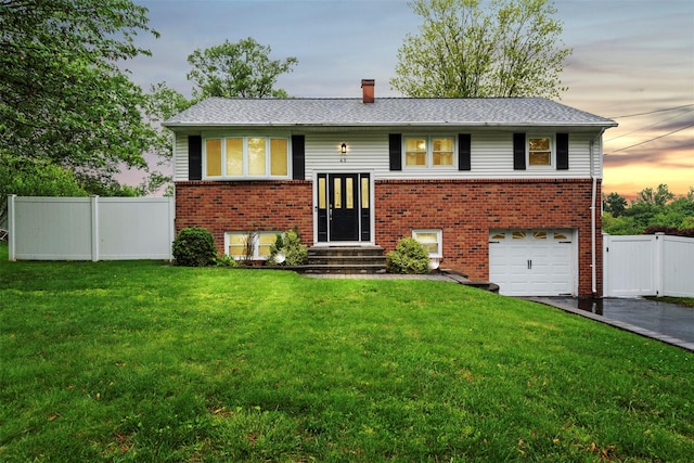 45 Maple Dr, Stony Point, NY 10980 - raised ranch featuring asphalt driveway, an attached garage, entry steps, and brick siding