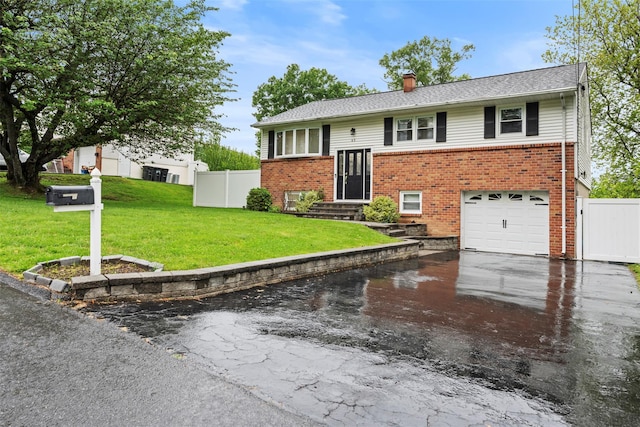 45 Maple Dr, Stony Point, NY 10980 - bi-level home featuring driveway, brick siding, a chimney, and an attached garage