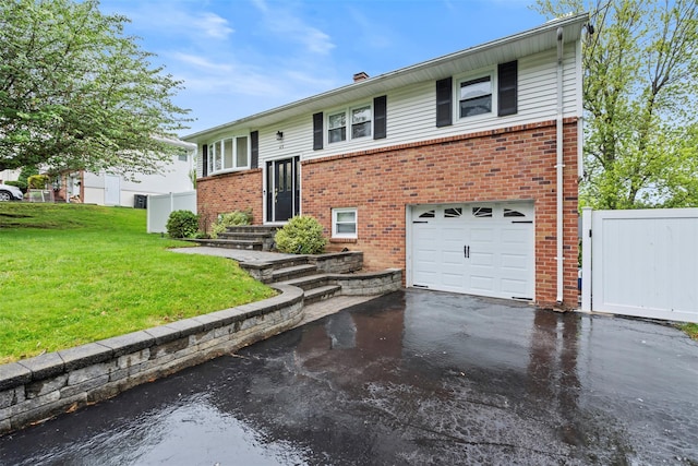45 Maple Dr, Stony Point, NY 10980 - bi-level home featuring an attached garage, asphalt driveway, brick siding, and a chimney