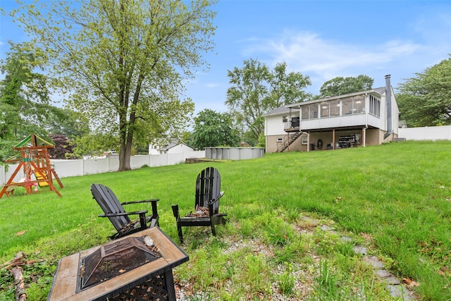 45 Maple Dr, Stony Point, NY 10980 - view of yard with a sunroom, an outdoor fire pit, stairs, and a playground
