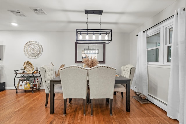 45 Maple Dr, Stony Point, NY 10980 - dining space featuring baseboard heating, wood finished floors, and baseboards