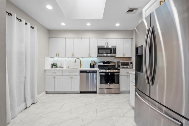45 Maple Dr, Stony Point, NY 10980 - kitchen featuring appliances with stainless steel finishes, recessed lighting, decorative backsplash, a sink, and light countertops