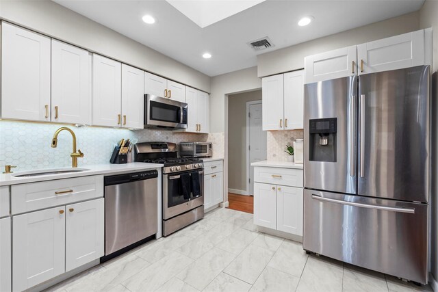 45 Maple Dr, Stony Point, NY 10980 - kitchen with stainless steel appliances, a sink, light countertops, recessed lighting, and backsplash
