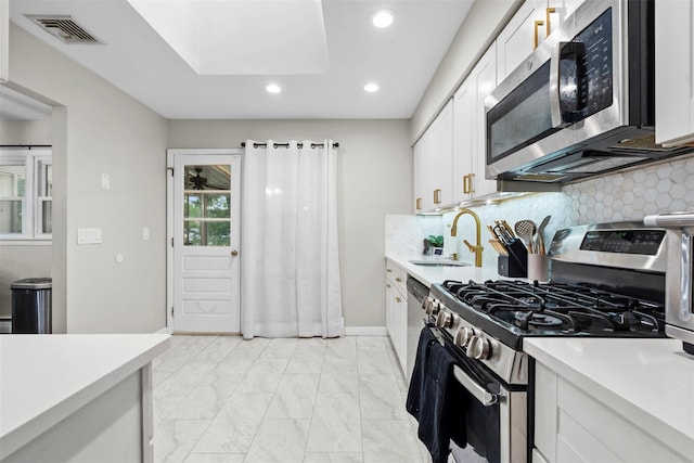 45 Maple Dr, Stony Point, NY 10980 - kitchen featuring stainless steel appliances, a sink, recessed lighting, light countertops, and white cabinets