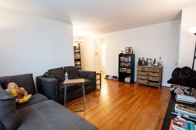 67-89 136th St Unit A, Kew Garden Hills, NY 11367 - living room with a chandelier and wood finished floors