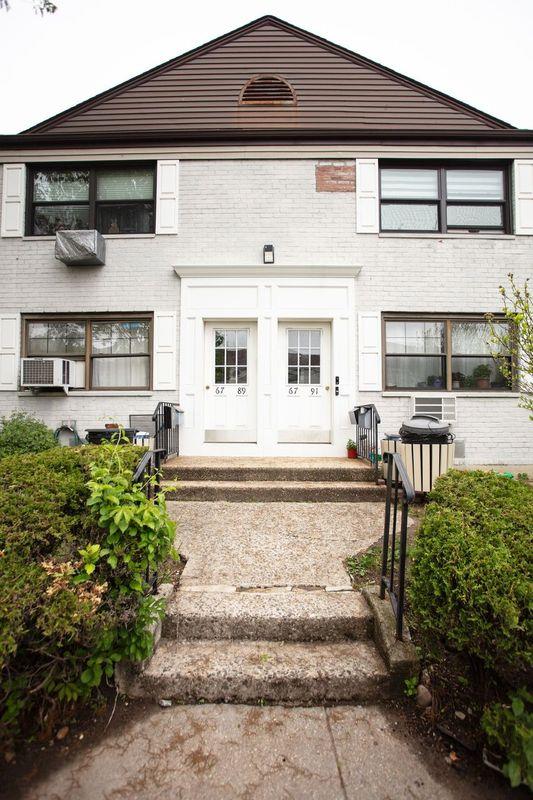 67-89 136th St Unit A, Kew Garden Hills, NY 11367 - property entrance featuring brick siding and cooling unit