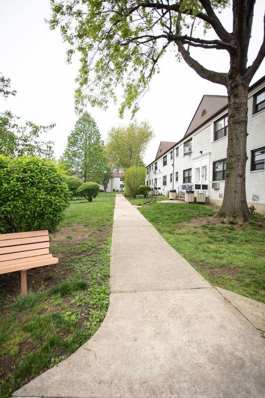 67-89 136th St Unit A, Kew Garden Hills, NY 11367 - view of community featuring a lawn and a residential view
