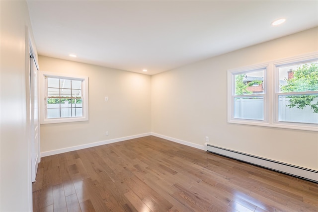 29 Underhill Ave, Syosset, NY 11791 - spare room with baseboard heating, wood finished floors, baseboards, and recessed lighting