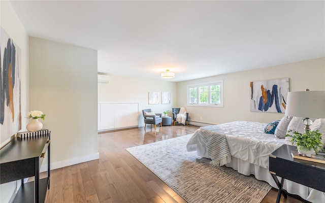 29 Underhill Ave, Syosset, NY 11791 - bedroom featuring a wall mounted air conditioner, wood finished floors, a baseboard radiator, and baseboards