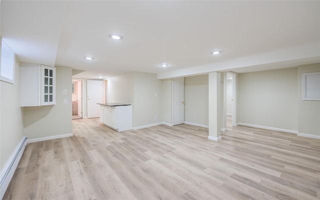 29 Underhill Ave, Syosset, NY 11791 - finished basement with baseboard heating, light wood-type flooring, recessed lighting, and baseboards