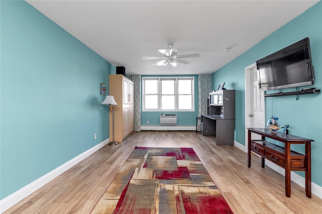 210 E Broadway Unit 1D, Long Beach, NY 11561 - living area featuring wood finished floors, a ceiling fan, and a baseboard heating unit