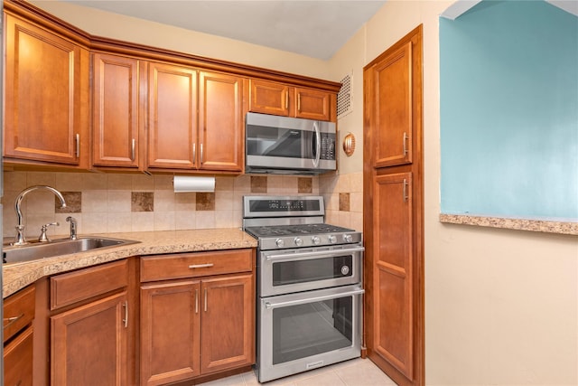 210 E Broadway Unit 1D, Long Beach, NY 11561 - kitchen with appliances with stainless steel finishes and brown cabinetry