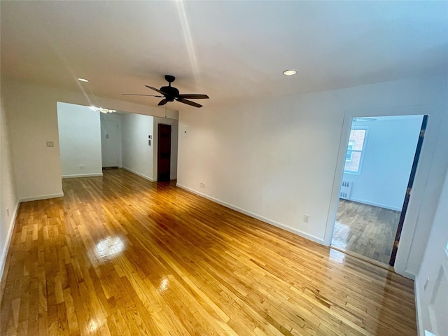 14340 41st Ave Unit 2G, Flushing, NY 11355 - empty room with light wood-style floors, ceiling fan, radiator, and baseboards