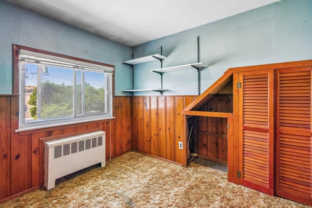 315 Fern Pl, Bethpage, NY 11714 - unfurnished bedroom with radiator heating unit, wood walls, and a wainscoted wall