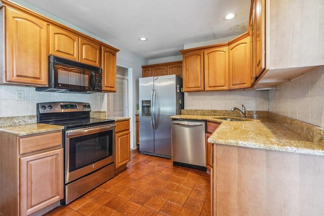315 Fern Pl, Bethpage, NY 11714 - kitchen with appliances with stainless steel finishes, a sink, tasteful backsplash, light stone counters, and recessed lighting