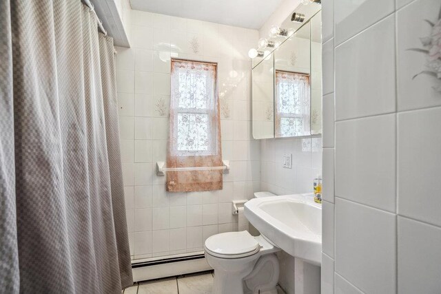 315 Fern Pl, Bethpage, NY 11714 - bathroom with a baseboard radiator, tile walls, toilet, tile patterned flooring, and curtained shower
