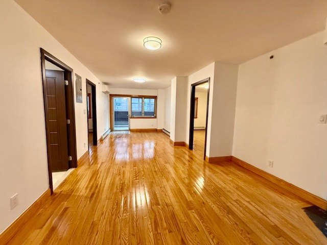 41-42 College Point Blvd Unit 3E, Flushing, NY 11355 - empty room featuring hardwood / wood-style flooring, baseboard heating, a smoke detector, and baseboards
