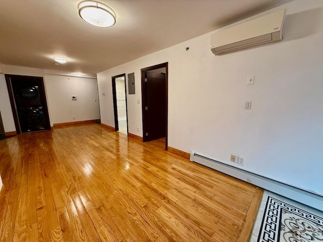 41-42 College Point Blvd Unit 3E, Flushing, NY 11355 - spare room featuring a wall mounted AC, stacked washer / drying machine, light wood finished floors, a baseboard radiator, and baseboards