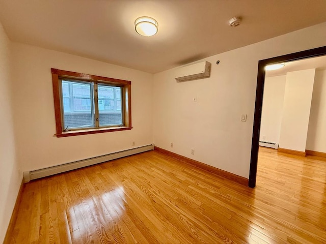 41-42 College Point Blvd Unit 3E, Flushing, NY 11355 - unfurnished room with a baseboard heating unit, an AC wall unit, light wood-style floors, and a smoke detector