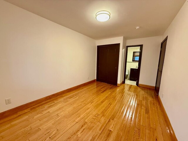 41-42 College Point Blvd Unit 3E, Flushing, NY 11355 - spare room with light wood finished floors and baseboards