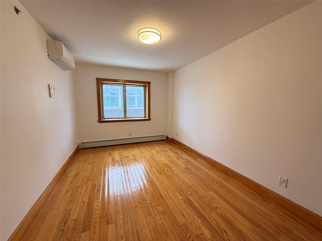 41-42 College Point Blvd Unit 3E, Flushing, NY 11355 - unfurnished room with baseboard heating, a wall mounted AC, light wood finished floors, and baseboards