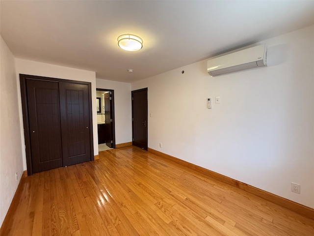 41-42 College Point Blvd Unit 3E, Flushing, NY 11355 - unfurnished bedroom with a wall mounted air conditioner, light wood-style flooring, and baseboards