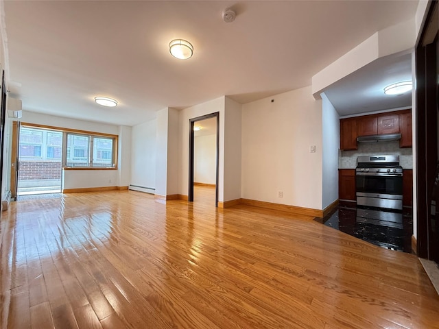 41-42 College Point Blvd Unit 3E, Flushing, NY 11355 - unfurnished living room with baseboard heating, light wood finished floors, and baseboards