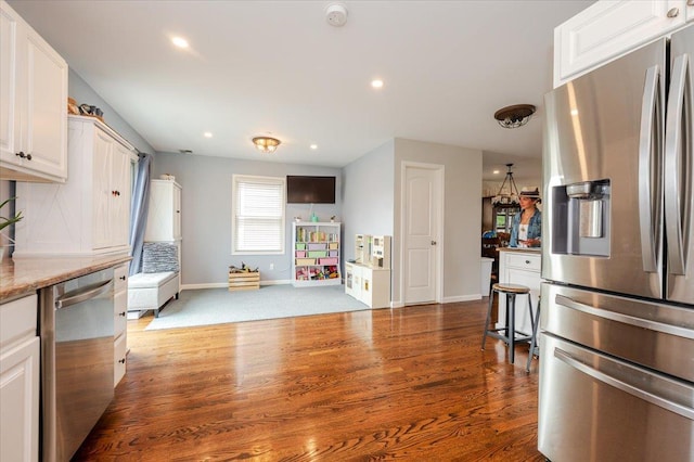 360 E Hudson St, Long Beach, NY 11561 - kitchen with appliances with stainless steel finishes, baseboards, white cabinets, wood finished floors, and recessed lighting