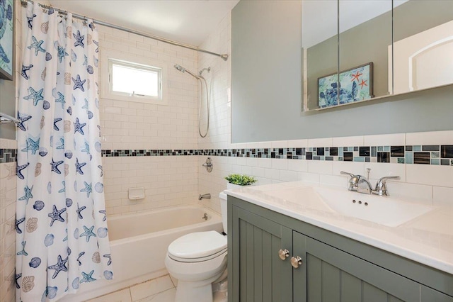 360 E Hudson St, Long Beach, NY 11561 - full bath featuring shower / tub combo with curtain, toilet, vanity, tile walls, and tile patterned flooring
