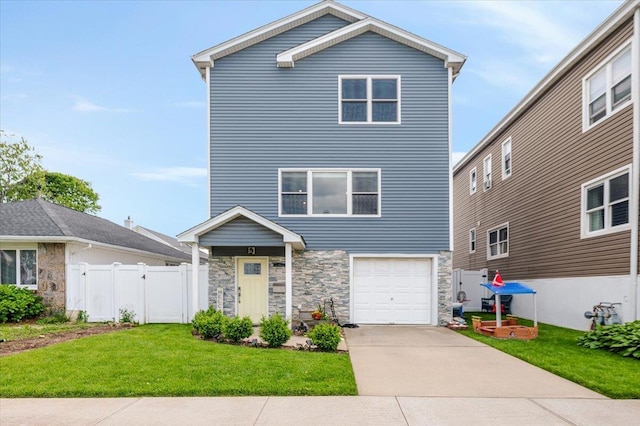 360 E Hudson St, Long Beach, NY 11561 - traditional-style home featuring stone siding, an attached garage, and driveway