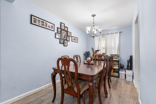 2 Cascade Ter Unit 1D, Yonkers, NY 10703 - dining room featuring a chandelier, light wood-style floors, and baseboards
