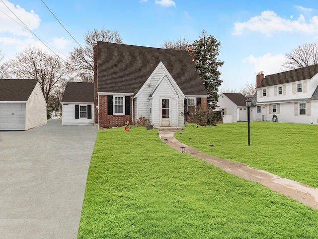 40 Mount Pleasant Rd, Yonkers, NY 10703 - cape cod-style house featuring an outbuilding, a front yard, and brick siding