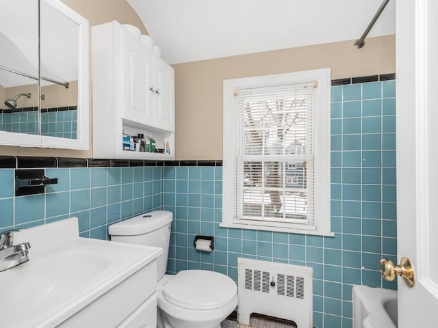 40 Mount Pleasant Rd, Yonkers, NY 10703 - bathroom with radiator, tile walls, vanity, washtub / shower combination, and toilet