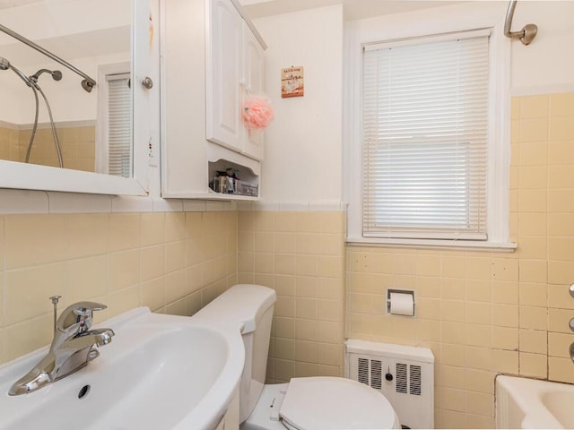 40 Mount Pleasant Rd, Yonkers, NY 10703 - bathroom featuring tile walls, a sink, radiator, and toilet