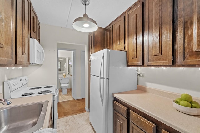 160 Academy St Unit 5C, Poughkeepsie, NY 12601 - kitchen with white appliances, a sink, hanging light fixtures, and light countertops
