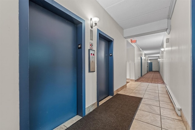 160 Academy St Unit 5C, Poughkeepsie, NY 12601 - hallway with elevator, baseboard heating, and tile patterned flooring