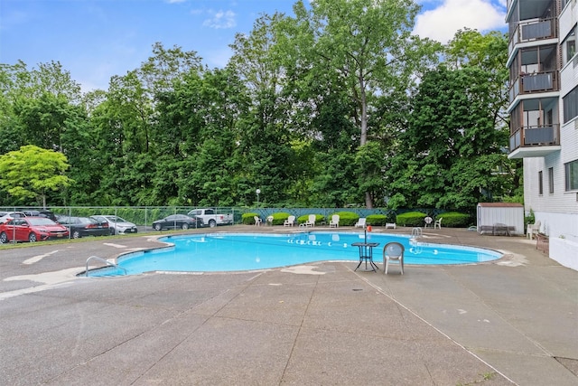 160 Academy St Unit 5C, Poughkeepsie, NY 12601 - community pool featuring a patio area and view of scattered trees